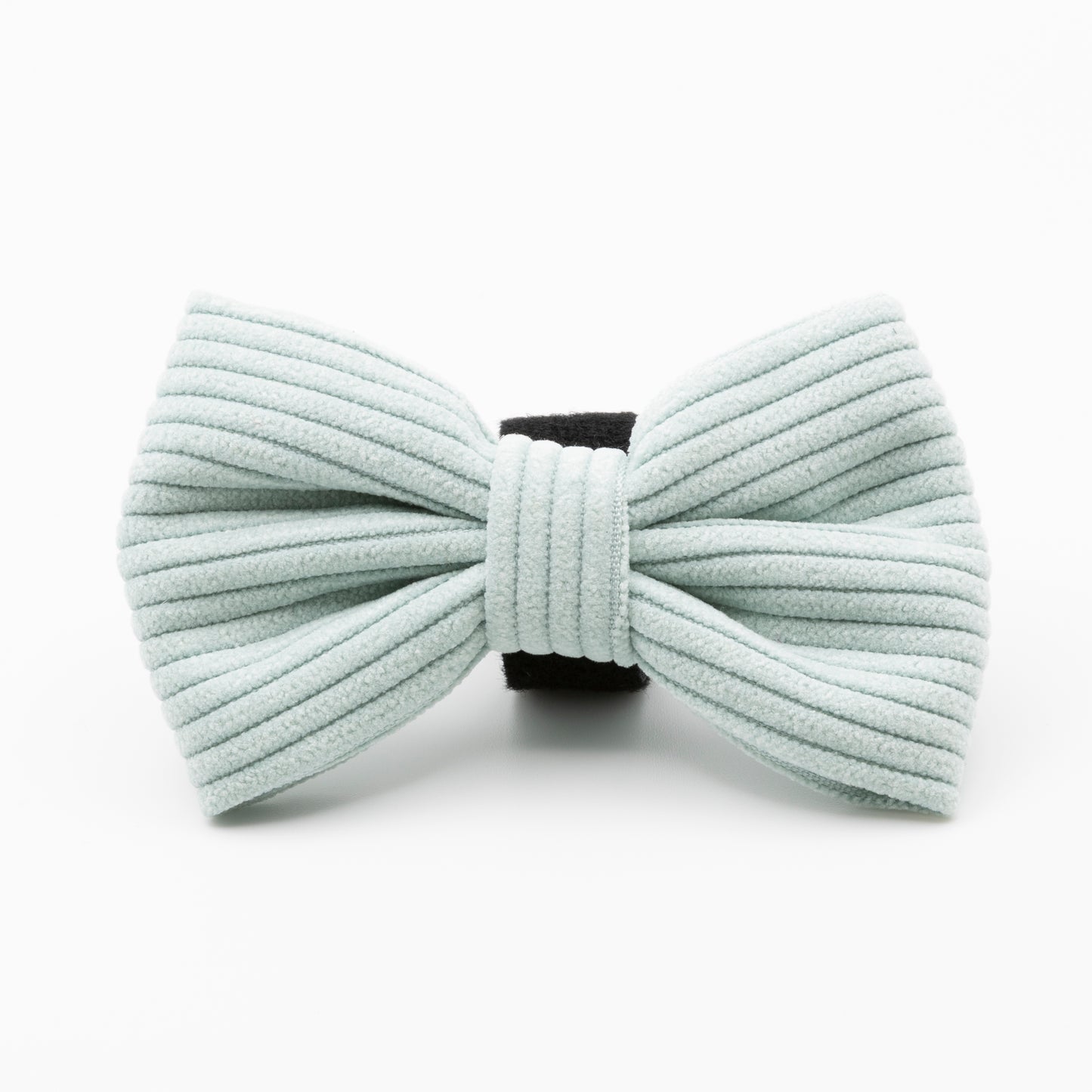 The Aqua Cord Dog Bow Tie, made of light blue ribbed fabric with a black center band, is a stylish and durable accessory for your dog, shown against a white background.
