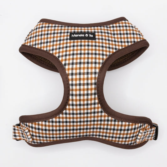 The Cocoa Heritage Lite Dog Harness features a brown, black, and white checkered pattern with brown trim and a black "Manala & bo" label. This lightweight, adjustable harness is shown on a white background.