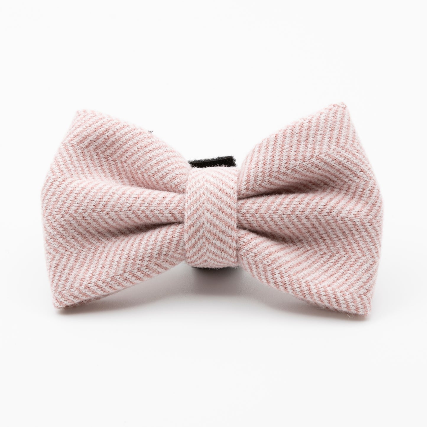 The Tea Rose Tweed Dog Bow Tie features a pale pink herringbone pattern, making it a stylish addition to your pet’s accessories and is shown here against a plain white background.