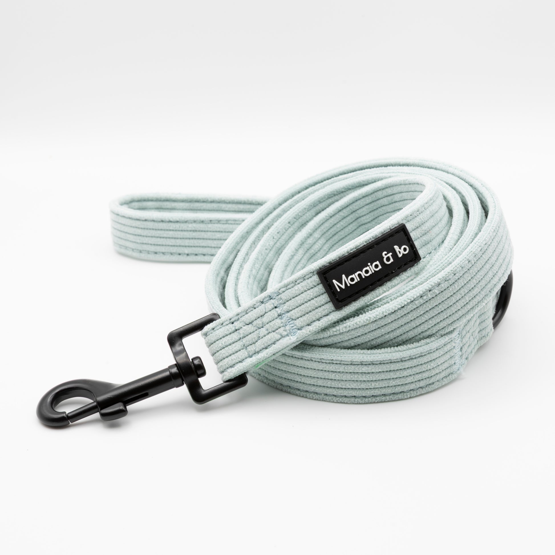 The Aqua Cord Dog Lead is a light blue, ribbed, fixed-length leash with a black clip and Marada & bo label—coiled neatly on a white background.