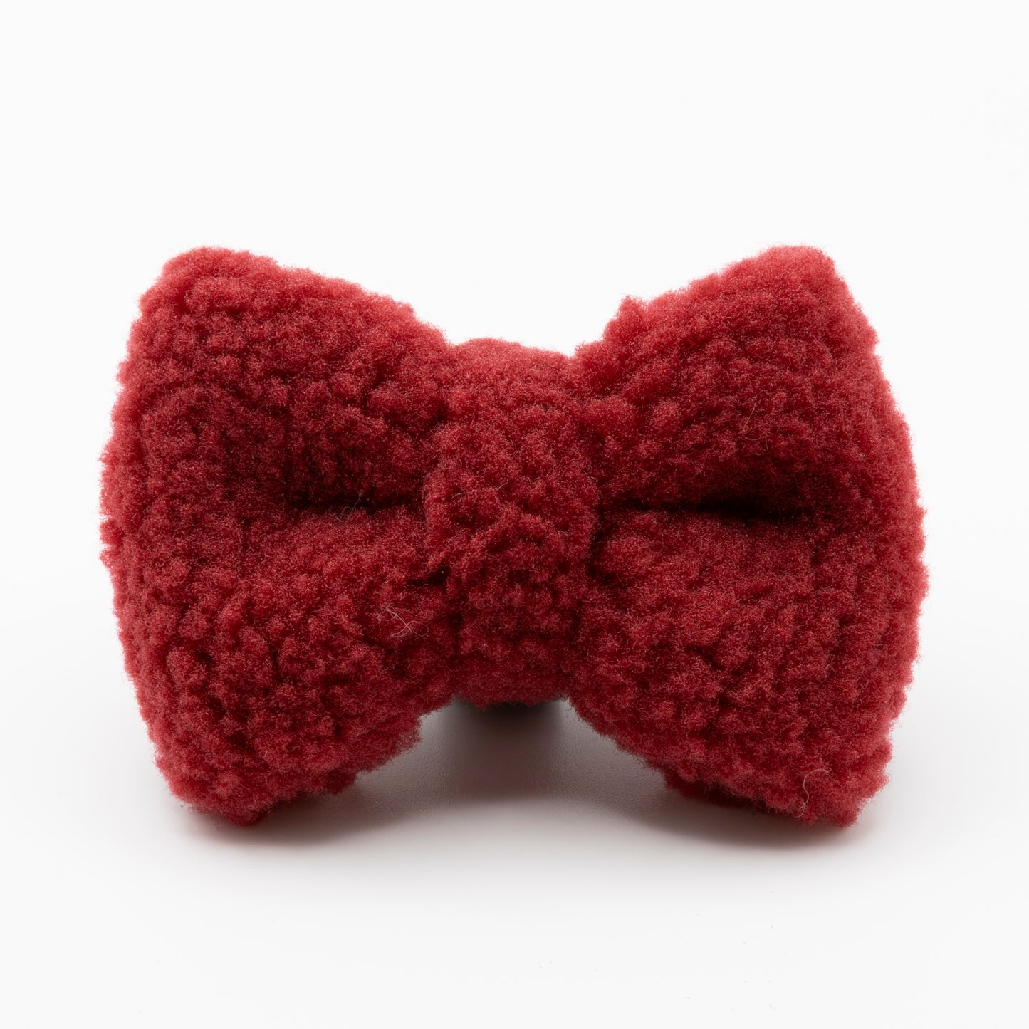 The Bordeaux Teddy Dog Bow Tie, made from soft textured red fabric, is shown on a plain white background—an elegant, adjustable accessory for your dog’s ultimate luxury look.
