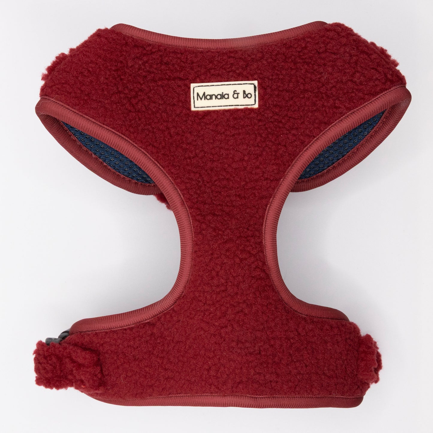 The Bordeaux Teddy Dog Harness is a red, fleece-lined, comfy pet harness for small to medium dogs, featuring a "Manala & bo" label on the front and shown against a plain white background.