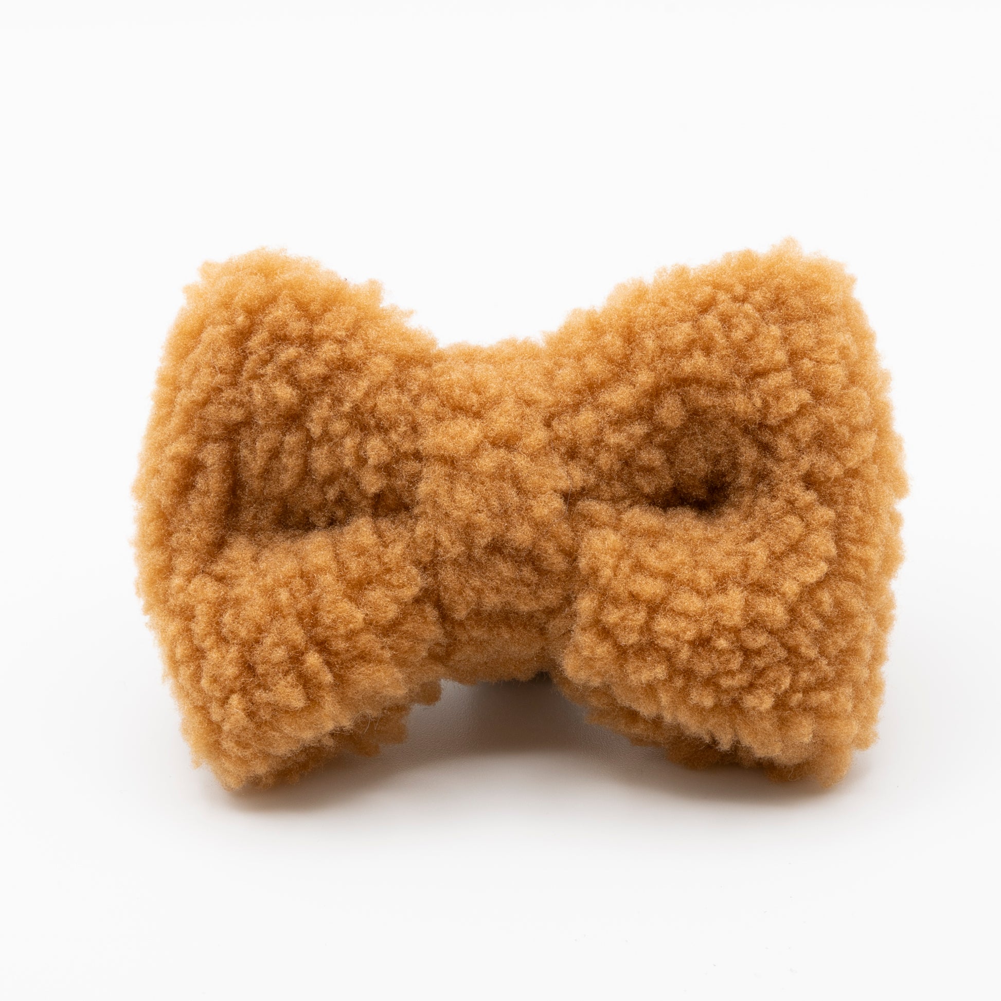 The Caramel Teddy Dog Bow Tie is a plush, textured bow tie for dogs made from soft, light brown fleece, displayed on a plain white background.