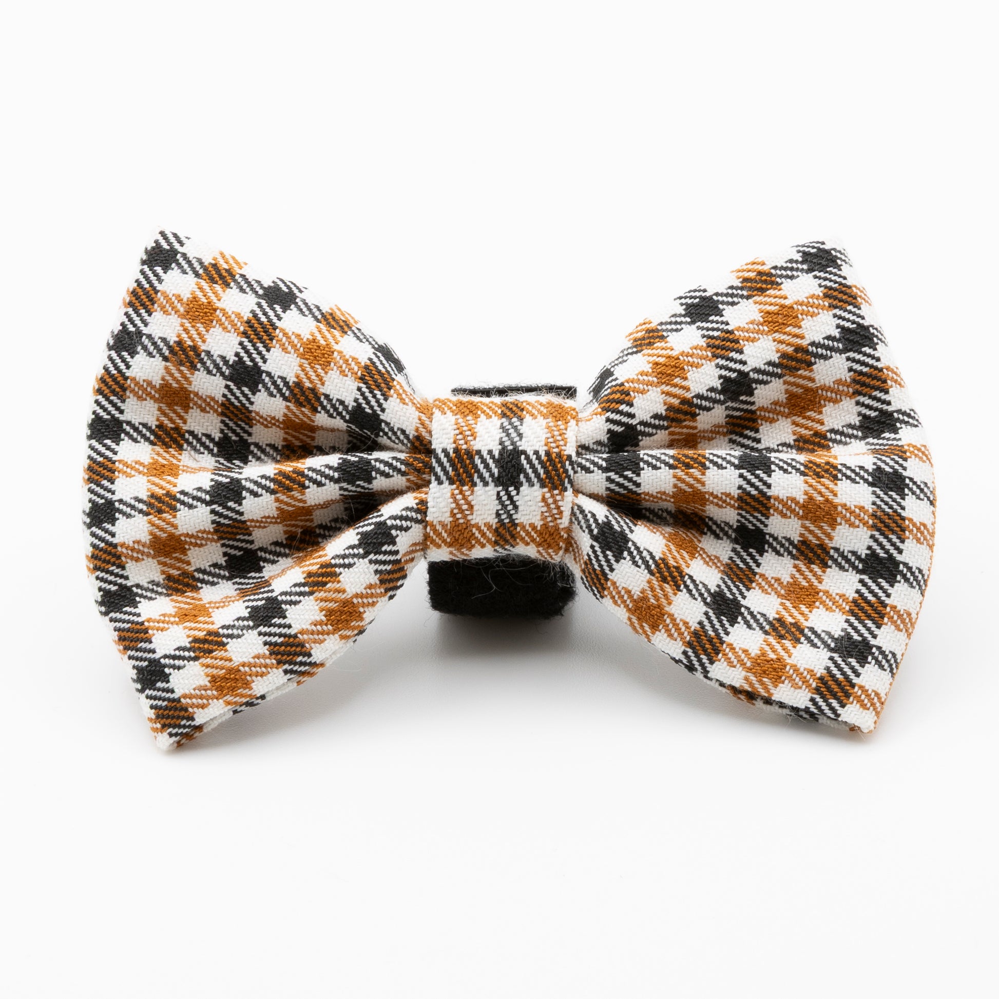 The Cocoa Heritage Lite Dog Bow Tie is a lightweight accessory in an orange, black, and white heritage check pattern, shown on a white background.