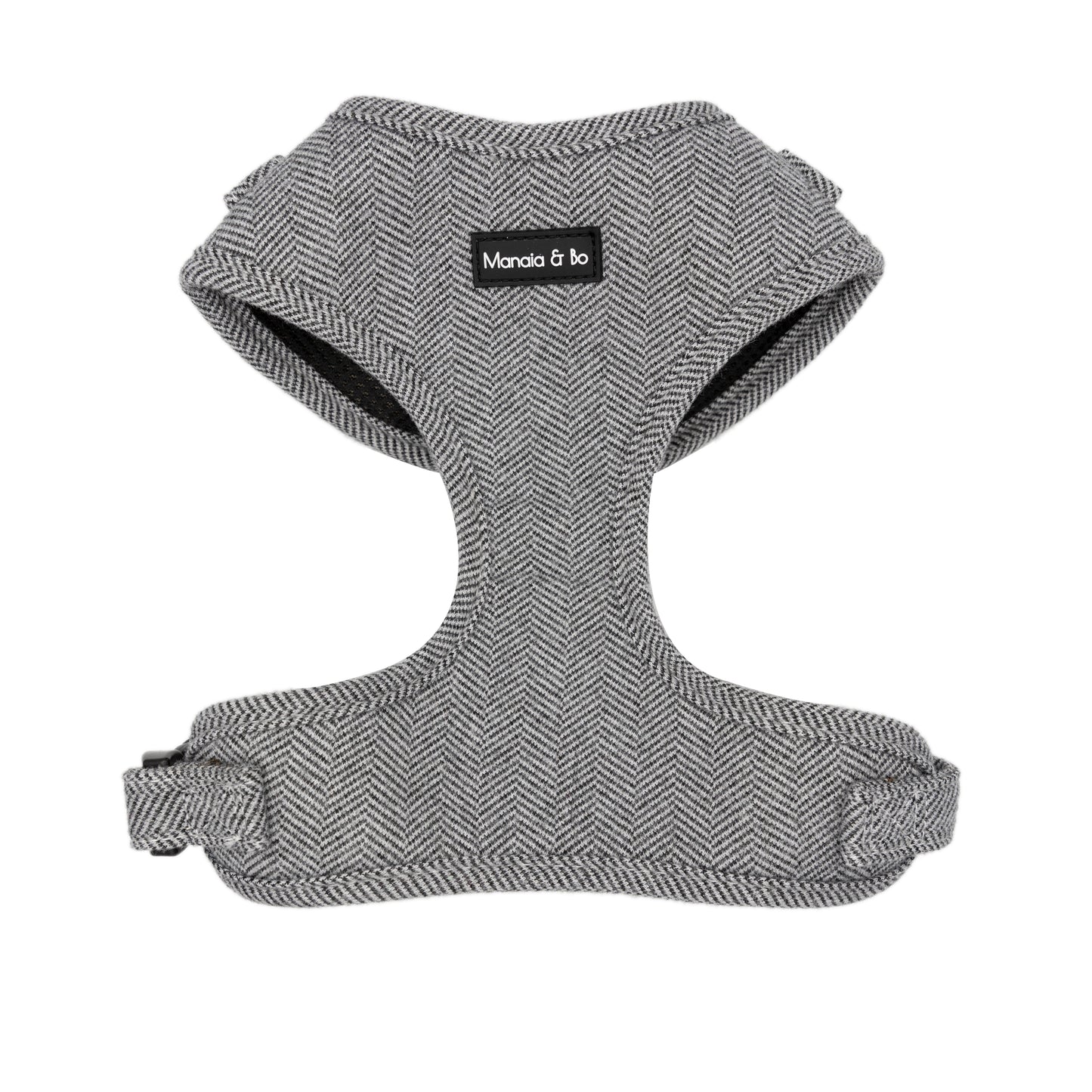 Monochrome (dark grey and white) tweed herringbone adjustable dog harness on a white background from the front.