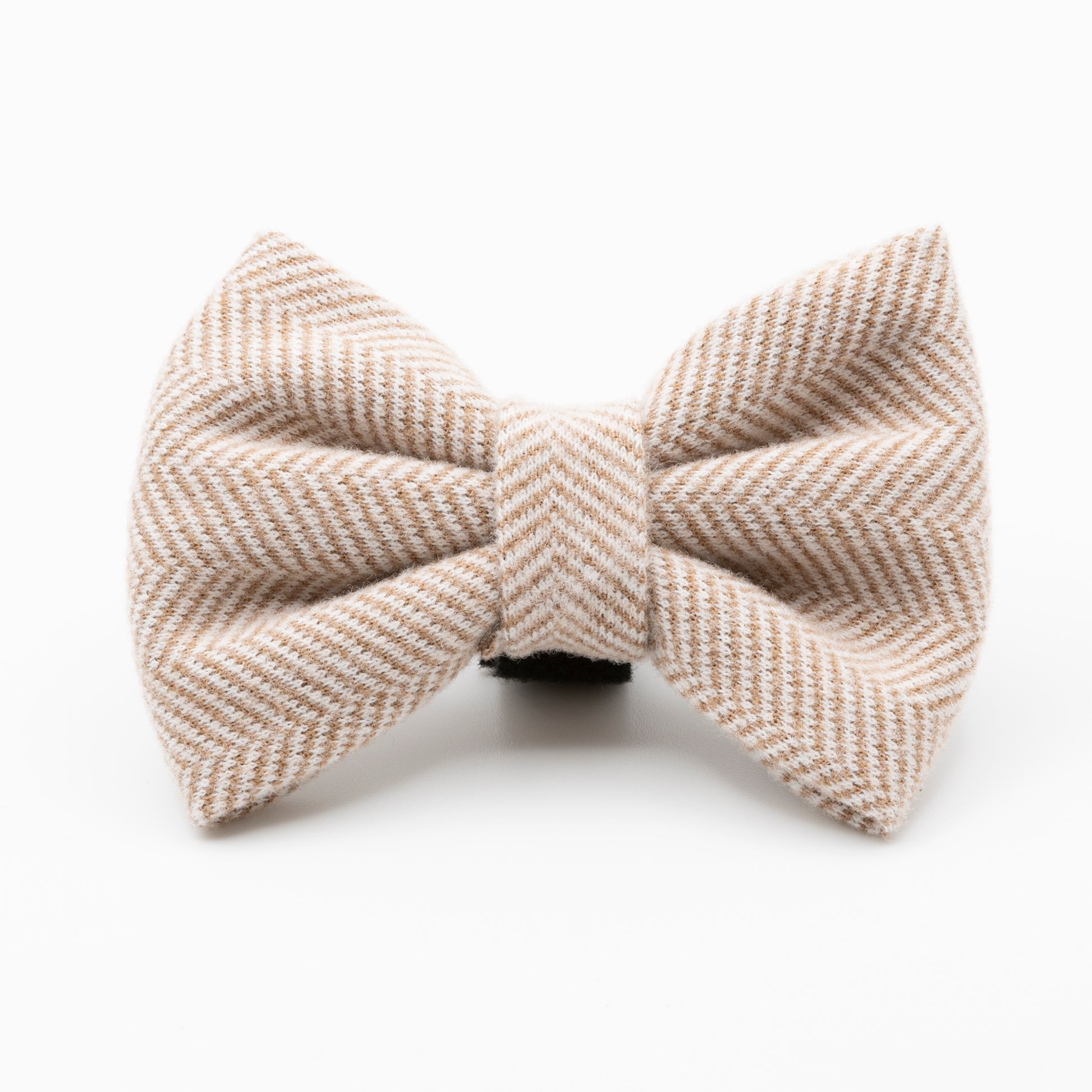 The Nougat Tweed Dog Bow Tie, featuring a beige and white herringbone pattern, is shown against a plain white background—an elegant herringbone dog accessory for your pup.