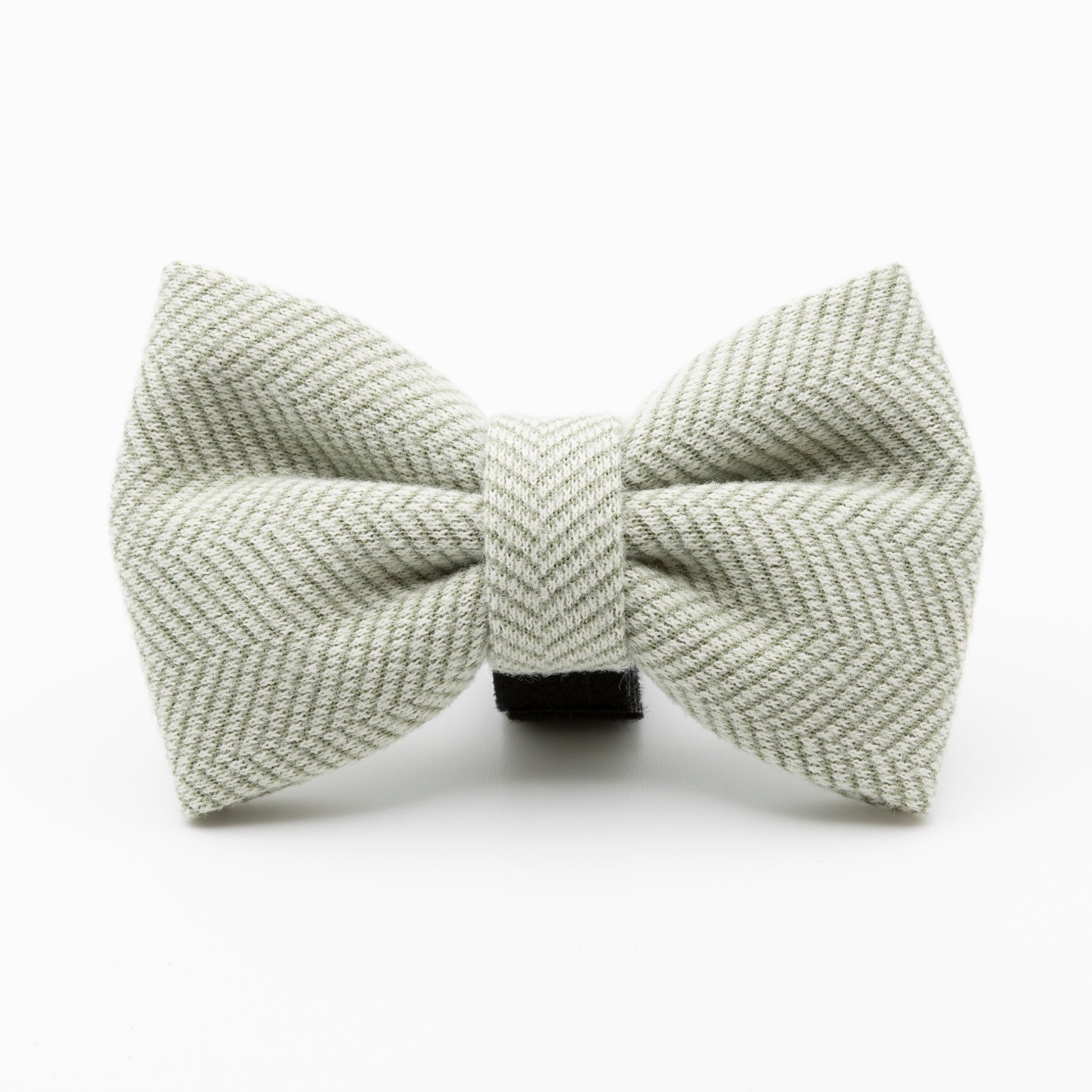 The Pine Tweed Dog Bow Tie features a light grey herringbone pattern and central knot, making it a stylish accessory for your dog. Displayed against a plain white background.
