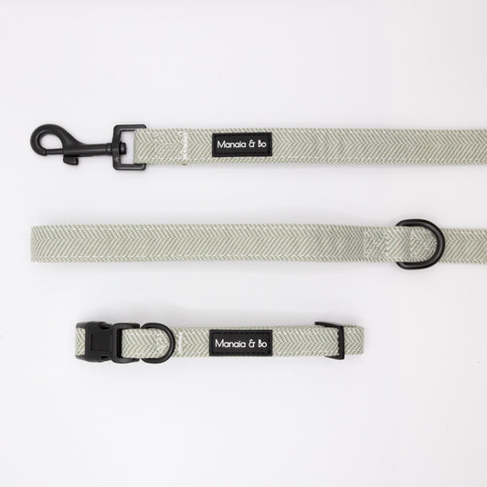 The Pine Tweed Collar & Lead set features a light gray herringbone-patterned adjustable dog collar and tweed lead with black hardware and Moncia & bo labels, shown on a white background.