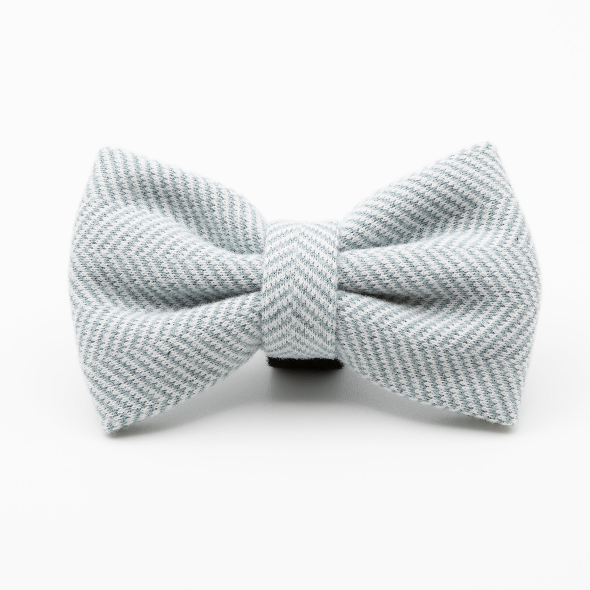 The Sky Tweed Dog Bow Tie features a light gray color with a subtle diagonal herringbone pattern—an elegant and stylish accessory for any dog.