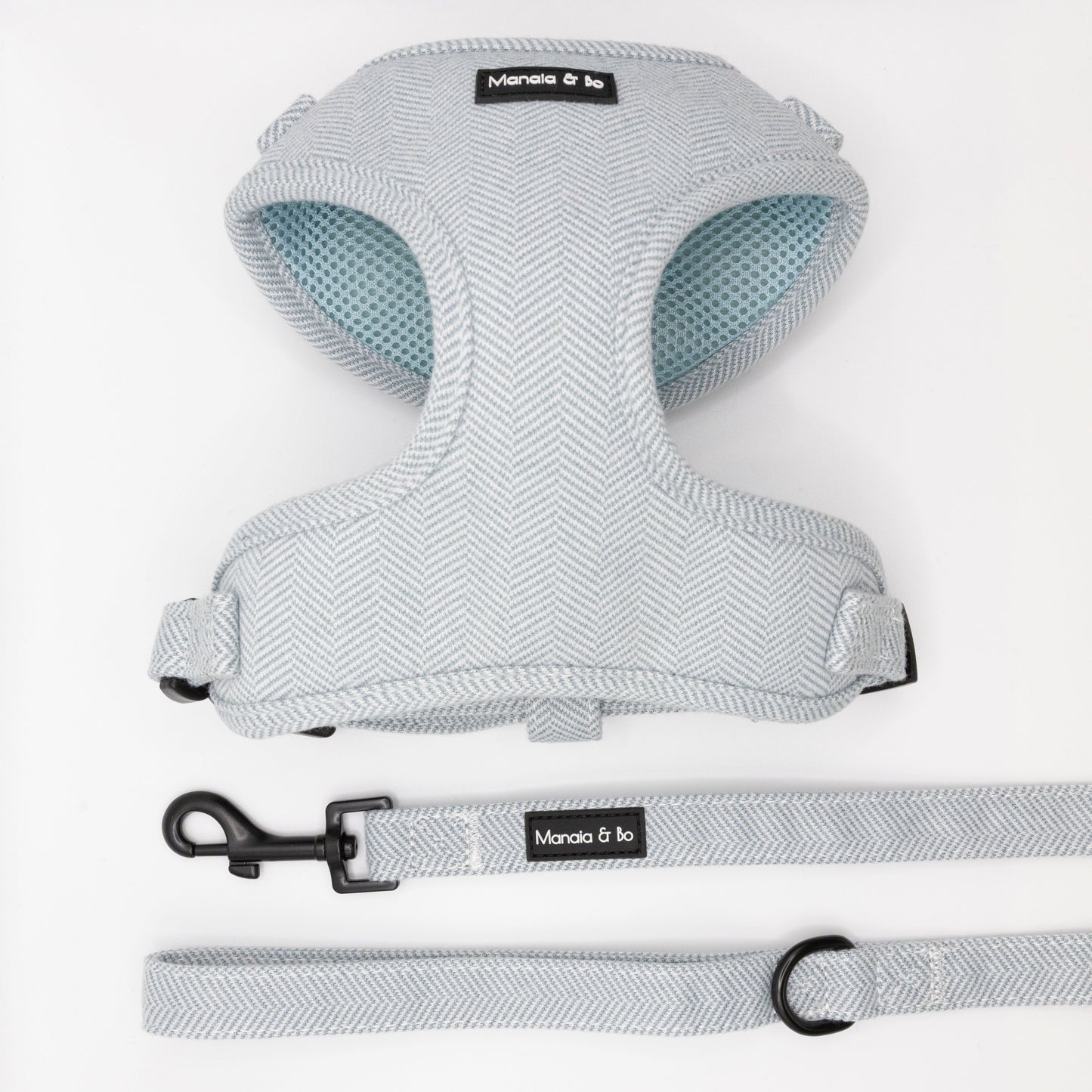 The Sky Tweed Harness & Lead features a light gray herringbone-patterned dog harness with matching leash, both labeled Monala & bo, displayed on a white background.
