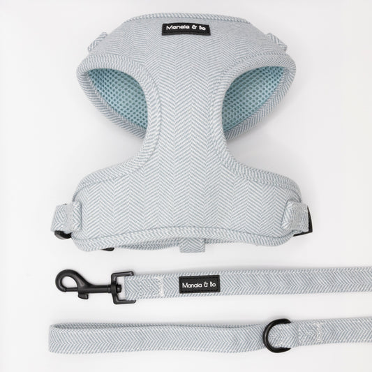 The Sky Tweed Harness & Lead features a light gray herringbone-patterned dog harness with matching leash, both labeled Monala & bo, displayed on a white background.