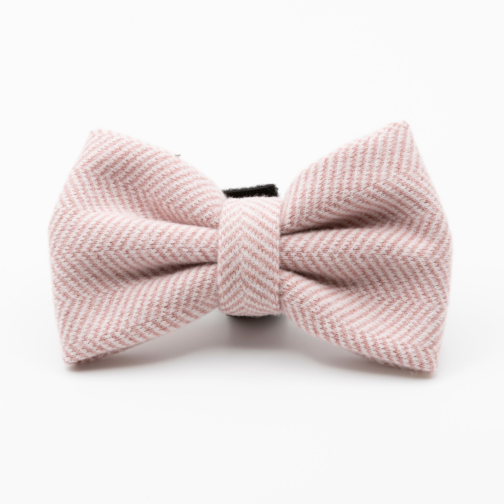 The Tea Rose Tweed Dog Bow Tie features a pale pink herringbone pattern, making it a stylish addition to your pet’s accessories and is shown here against a plain white background.