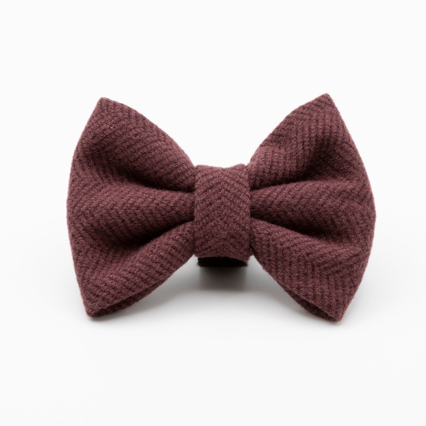 The Wild Plum Tweed Dog Bow Tie, in a maroon textured fabric, is displayed on a plain white background—an ideal luxury accessory for any stylish pup.