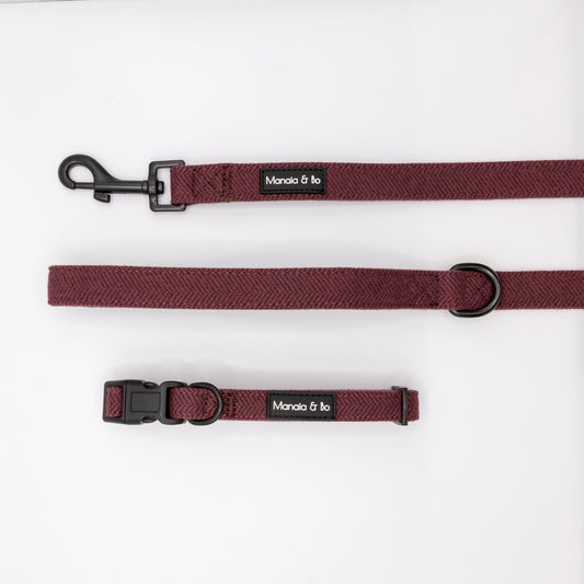 A Wild Plum Tweed Collar & Lead set by Monata & bo is shown on a white background, featuring a maroon tweed collar and adjustable leash with metal clasp.