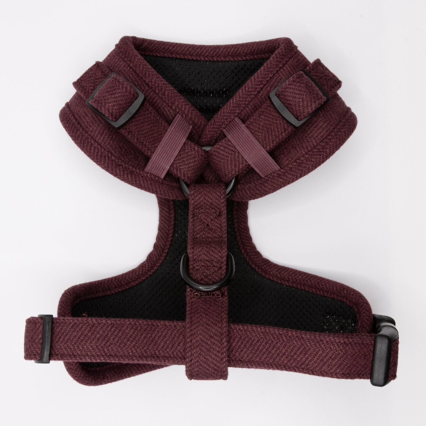 The Wild Plum Tweed Harness & Lead is a maroon adjustable dog harness with black buckles and a D-ring, designed for small to medium dogs for a comfy chest and shoulder fit, shown on a white background.