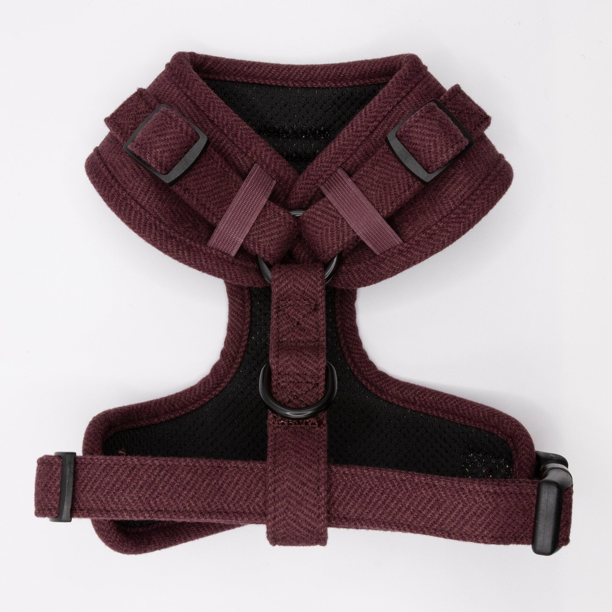 The Wild Plum Tweed Harness & Lead is a maroon adjustable dog harness with black buckles and a D-ring, designed for small to medium dogs for a comfy chest and shoulder fit, shown on a white background.
